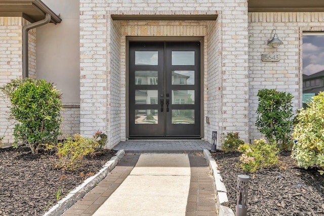 15643 Thirsty Horse Trl, Cypress, TX 77433 - view of exterior entry with french doors and brick siding