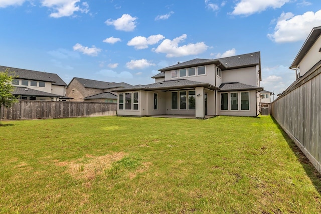 15643 Thirsty Horse Trl, Cypress, TX 77433 - back of house with a fenced backyard, stucco siding, and a patio