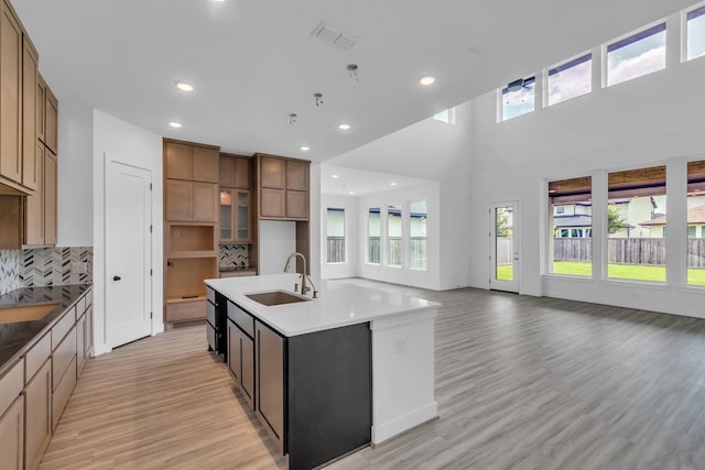 15643 Thirsty Horse Trl, Cypress, TX 77433 - kitchen featuring healthy amount of natural light, light wood finished floors, decorative backsplash, open floor plan, and recessed lighting