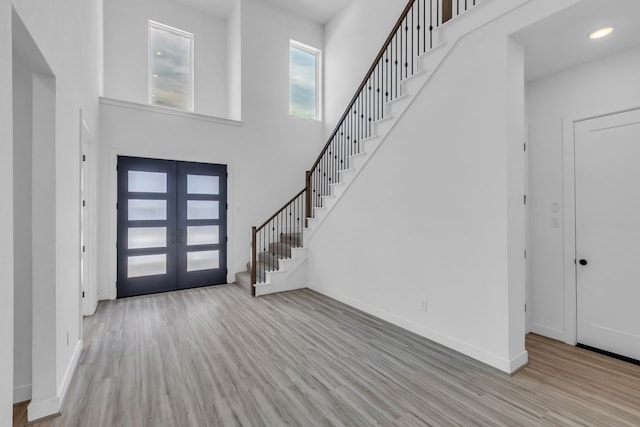 15643 Thirsty Horse Trl, Cypress, TX 77433 - foyer featuring wood finished floors, french doors, a towering ceiling, stairway, and recessed lighting