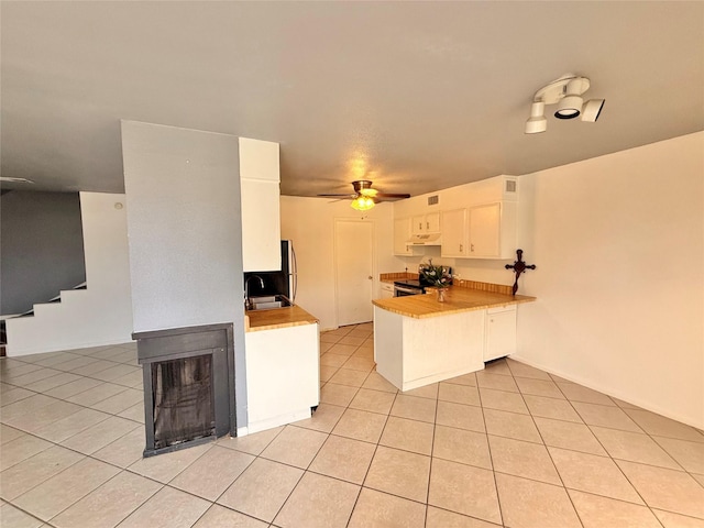 5915 Fairmeadow Dr, Beaumont, TX 77707 - kitchen featuring stainless steel range with electric cooktop, a peninsula, light tile patterned flooring, white cabinets, and a ceiling fan