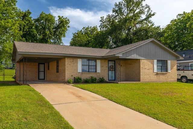 706 Matilda St, Brenham, TX 77833 - ranch-style home with brick siding, concrete driveway, a front lawn, and an attached carport