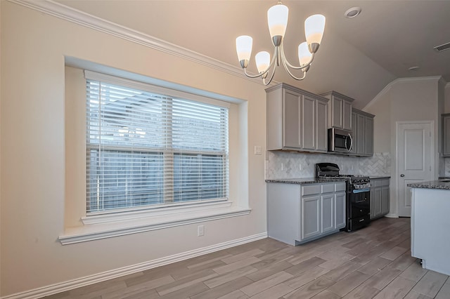 1111 Teamriddle Way, Richmond, TX 77406 - kitchen featuring gas stove, stainless steel microwave, gray cabinetry, decorative backsplash, and light wood-style floors