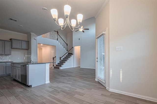 1111 Teamriddle Way, Richmond, TX 77406 - kitchen featuring gray cabinetry, crown molding, a chandelier, light wood-style floors, and tasteful backsplash