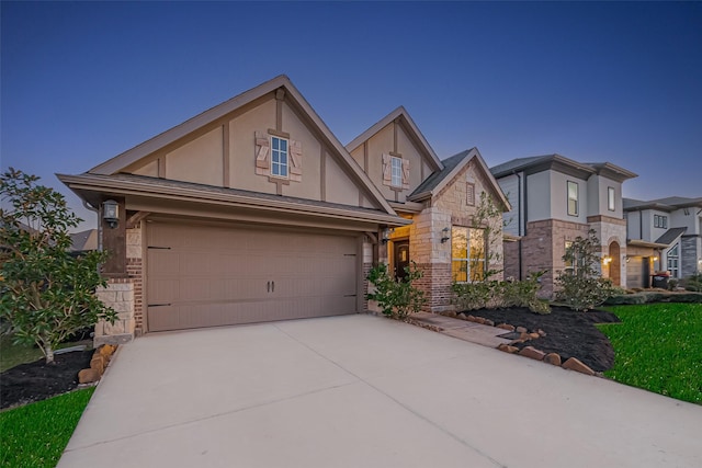 1111 Teamriddle Way, Richmond, TX 77406 - view of front of house with stucco siding, stone siding, concrete driveway, and a garage