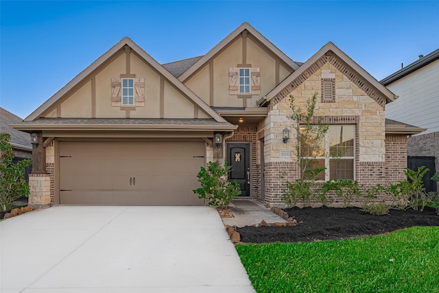 1111 Teamriddle Way, Richmond, TX 77406 - view of front of home with stucco siding, driveway, stone siding, brick siding, and a garage