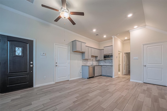 1111 Teamriddle Way, Richmond, TX 77406 - kitchen featuring appliances with stainless steel finishes, gray cabinets, a ceiling fan, light wood finished floors, and ornamental molding