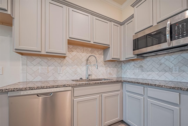 1111 Teamriddle Way, Richmond, TX 77406 - kitchen with appliances with stainless steel finishes, ornamental molding, backsplash, and dark stone counters