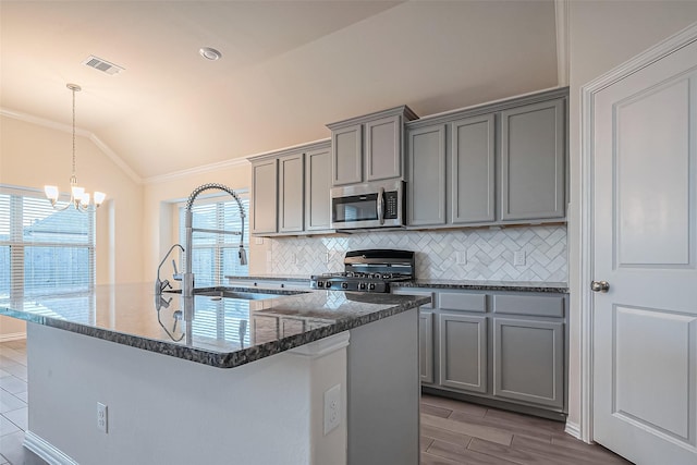 1111 Teamriddle Way, Richmond, TX 77406 - kitchen featuring range, gray cabinets, stainless steel microwave, crown molding, and lofted ceiling