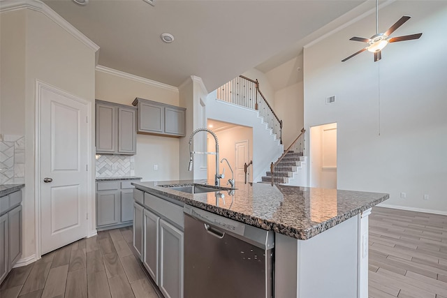 1111 Teamriddle Way, Richmond, TX 77406 - kitchen with stainless steel dishwasher, gray cabinetry, a ceiling fan, light wood-type flooring, and crown molding