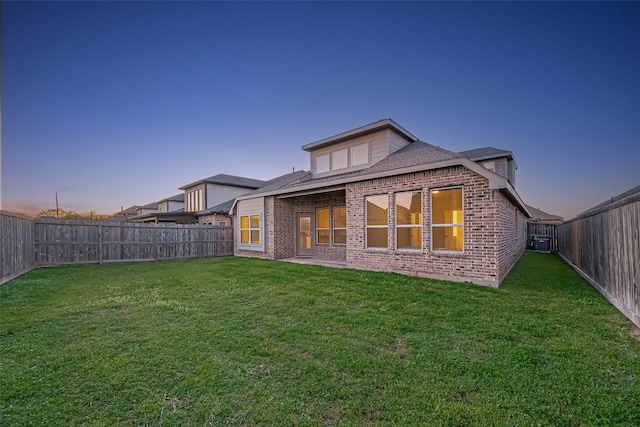 1111 Teamriddle Way, Richmond, TX 77406 - back of property at dusk with brick siding and a fenced backyard