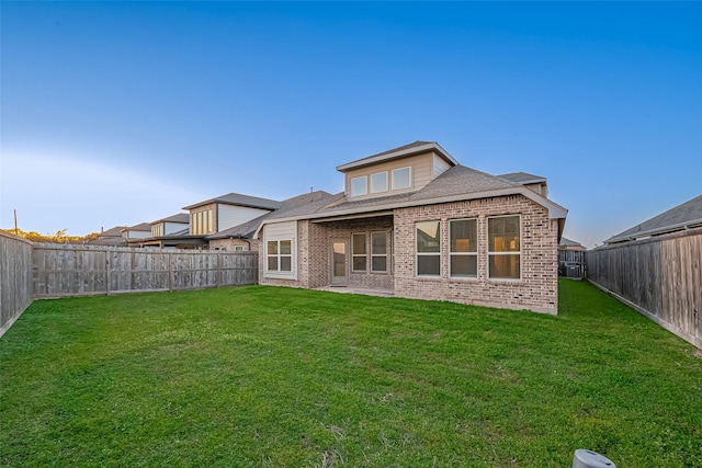 1111 Teamriddle Way, Richmond, TX 77406 - back of property featuring brick siding, a fenced backyard, and a shingled roof