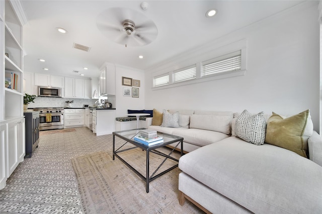 604 E 10th 1/2 St, Houston, TX 77008 - living room with ceiling fan, recessed lighting, and ornamental molding