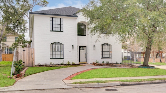 4400 Edith St, Bellaire, TX 77401 - french provincial home featuring a shingled roof and brick siding