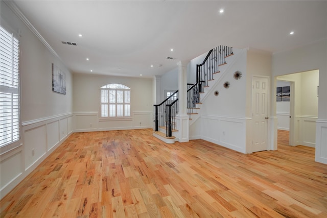 4400 Edith St, Bellaire, TX 77401 - unfurnished living room with a decorative wall, light wood-type flooring, stairway, wainscoting, and recessed lighting
