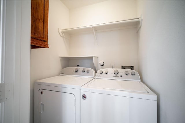 4400 Edith St, Bellaire, TX 77401 - laundry room featuring washer and clothes dryer and cabinet space