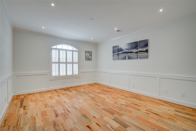 4400 Edith St, Bellaire, TX 77401 - empty room featuring crown molding, wood finished floors, a wainscoted wall, recessed lighting, and a decorative wall