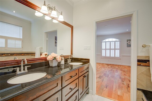 4400 Edith St, Bellaire, TX 77401 - bathroom featuring double vanity, crown molding, and wood finished floors