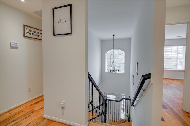 4400 Edith St, Bellaire, TX 77401 - stairway featuring wood finished floors, a chandelier, and healthy amount of natural light