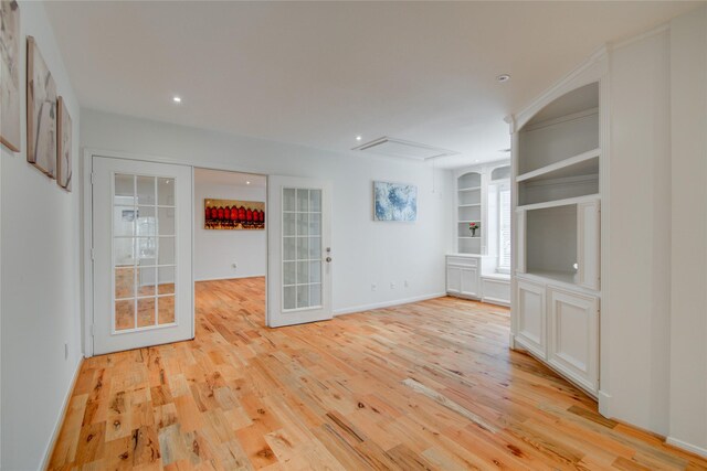 4400 Edith St, Bellaire, TX 77401 - unfurnished living room featuring light wood-style floors, built in shelves, and recessed lighting