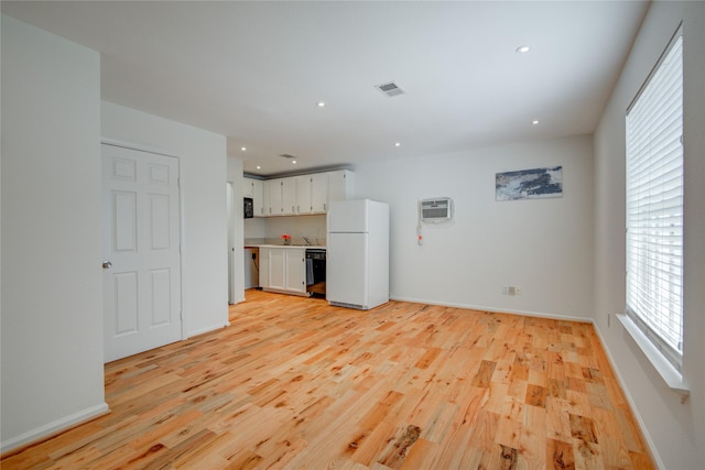 4400 Edith St, Bellaire, TX 77401 - unfurnished living room featuring light wood finished floors, recessed lighting, and a wall unit AC