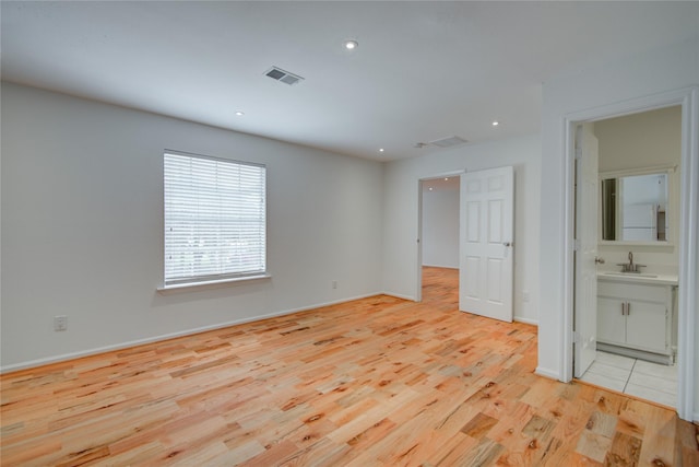 4400 Edith St, Bellaire, TX 77401 - unfurnished bedroom featuring light wood-type flooring, recessed lighting, and ensuite bathroom