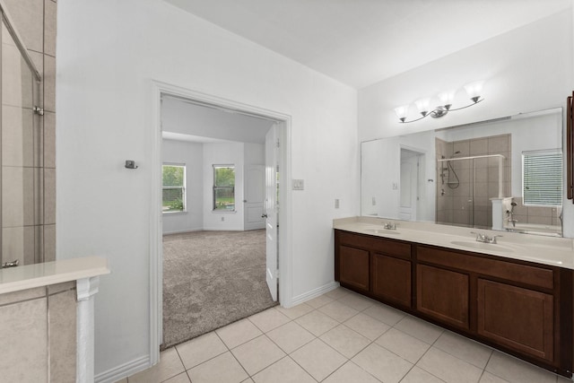 22303 Mosshall Ct, Tomball, TX 77375 - full bath featuring a shower stall, double vanity, and tile patterned floors