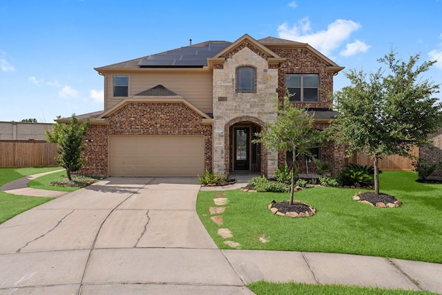 22303 Mosshall Ct, Tomball, TX 77375 - view of front of house with roof mounted solar panels, concrete driveway, brick siding, and an attached garage