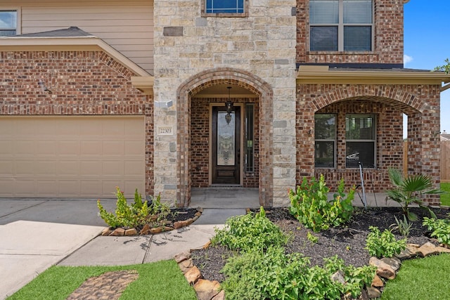 22303 Mosshall Ct, Tomball, TX 77375 - property entrance with covered porch, brick siding, and concrete driveway