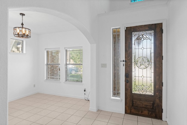 22303 Mosshall Ct, Tomball, TX 77375 - foyer with arched walkways, a chandelier, and light tile patterned floors