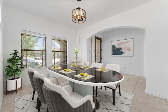 22303 Mosshall Ct, Tomball, TX 77375 - dining area with arched walkways, a chandelier, and light tile patterned floors
