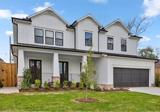 4902 Oak Forest Dr, Houston, TX 77018 - view of front of home with a garage, covered porch, board and batten siding, and concrete driveway