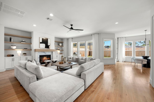 4902 Oak Forest Dr, Houston, TX 77018 - living area with a fireplace, recessed lighting, a ceiling fan, and light wood-style floors