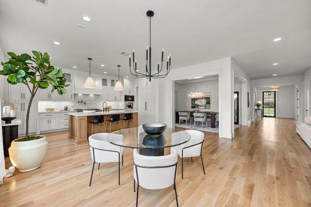 4902 Oak Forest Dr, Houston, TX 77018 - dining area with a chandelier, recessed lighting, and light wood-style flooring