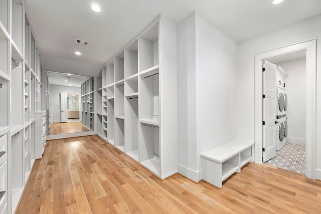 4902 Oak Forest Dr, Houston, TX 77018 - hallway featuring estacked washer and dryer, light wood-style floors, and recessed lighting