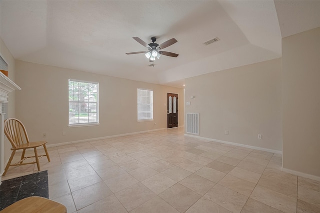 21319 Park Mill Dr, Katy, TX 77450 - spare room featuring ceiling fan, light tile patterned floors, a raised ceiling, and a tile fireplace