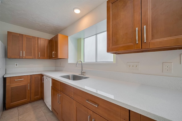 21319 Park Mill Dr, Katy, TX 77450 - kitchen with brown cabinets, dishwasher, light tile patterned floors, and a textured ceiling