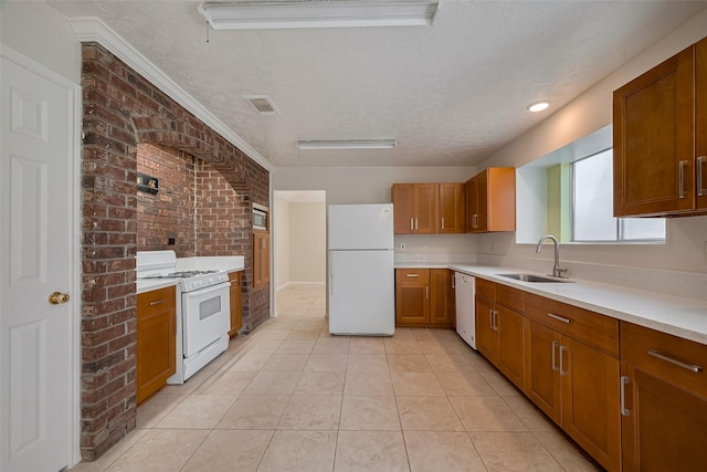 21319 Park Mill Dr, Katy, TX 77450 - kitchen with white appliances, a textured ceiling, brown cabinets, light countertops, and light tile patterned floors
