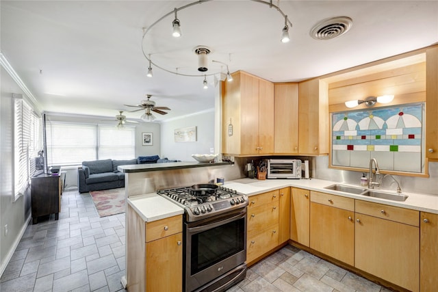 1522 Glen Oaks St, Houston, TX 77008 - kitchen with stainless steel gas stove, light brown cabinets, crown molding, a peninsula, and open floor plan