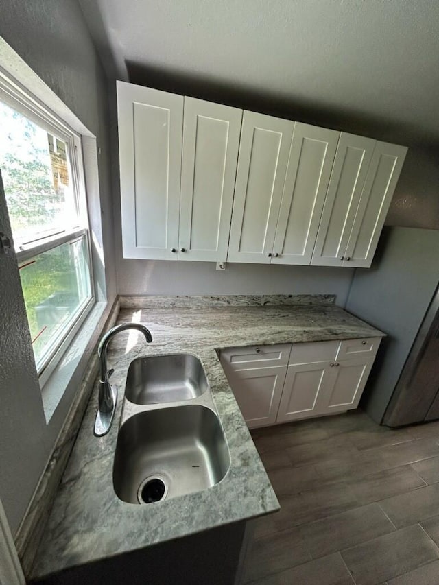1108 Niagara St, Houston, TX 77051 - kitchen featuring white cabinets, light stone countertops, and dark wood-type flooring
