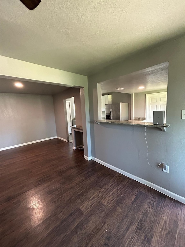 1108 Niagara St, Houston, TX 77051 - unfurnished living room with dark wood-style flooring and a textured ceiling