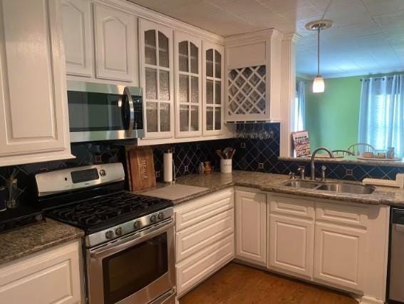 160 E Darby St, Bridge City, TX 77611 - kitchen featuring appliances with stainless steel finishes, white cabinets, and glass insert cabinets