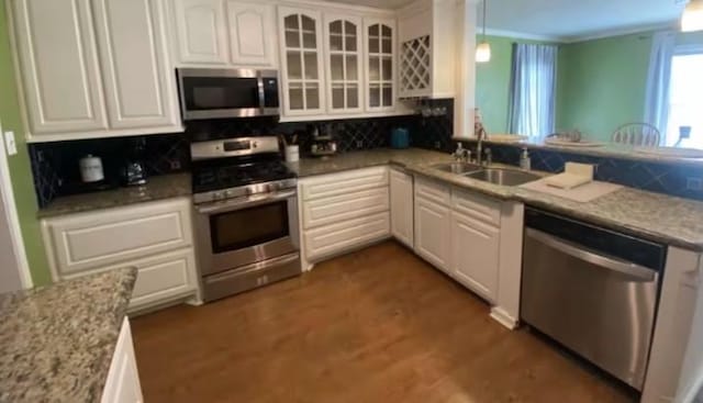 160 E Darby St, Bridge City, TX 77611 - kitchen featuring stainless steel appliances, backsplash, white cabinets, and glass insert cabinets