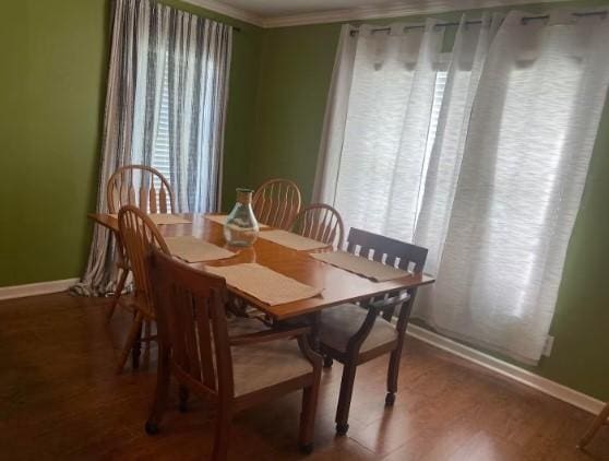 160 E Darby St, Bridge City, TX 77611 - dining area featuring ornamental molding and wood finished floors