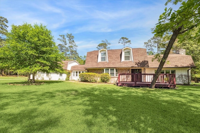 33410 Cripple Creek Dr, Pinehurst, TX 77362 - view of front of home with a front yard, a chimney, a wooden deck, and a shingled roof