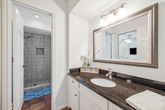 33410 Cripple Creek Dr, Pinehurst, TX 77362 - full bath featuring vanity, tiled shower, ceiling fan, and tile patterned flooring
