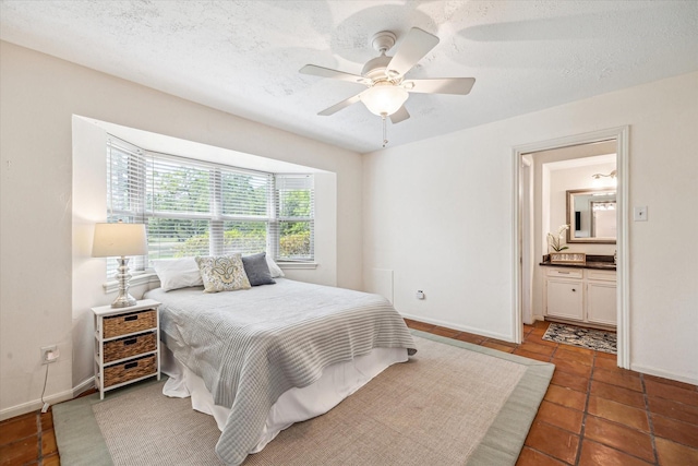 33410 Cripple Creek Dr, Pinehurst, TX 77362 - bedroom featuring tile patterned flooring, a ceiling fan, a textured ceiling, and ensuite bathroom