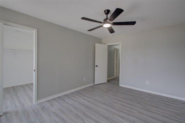 11623 Silent Elm St, Houston, TX 77044 - unfurnished bedroom with wood finished floors, a spacious closet, a ceiling fan, and a closet