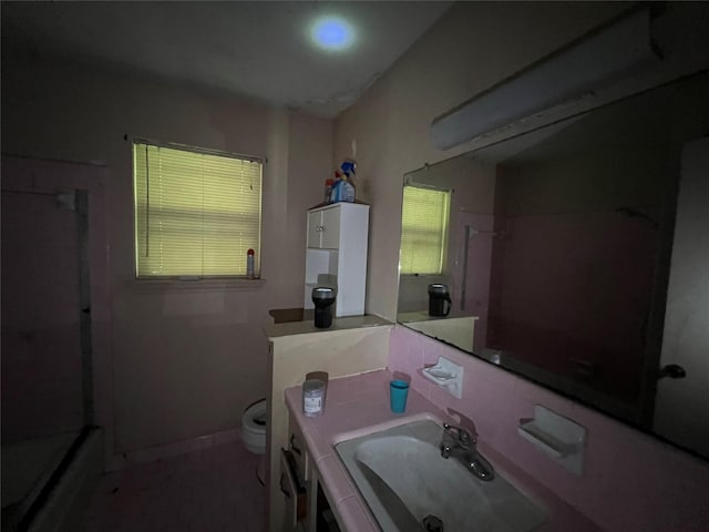3709 Kettering Ave, Bay City, TX 77414 - bathroom featuring a shower, vanity, and healthy amount of natural light