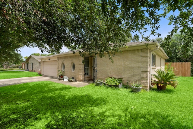 4002 Ebbtide Drive St, Houston, TX 77045 - view of front facade featuring driveway, a garage, and brick siding